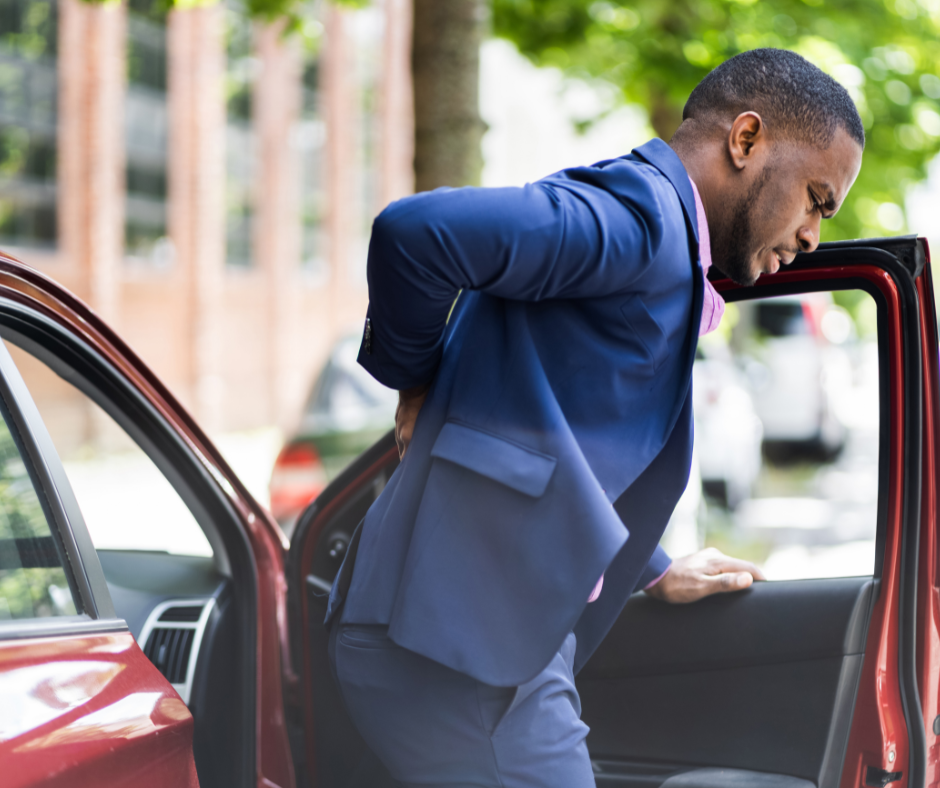 passenger of car accident holding back in pain